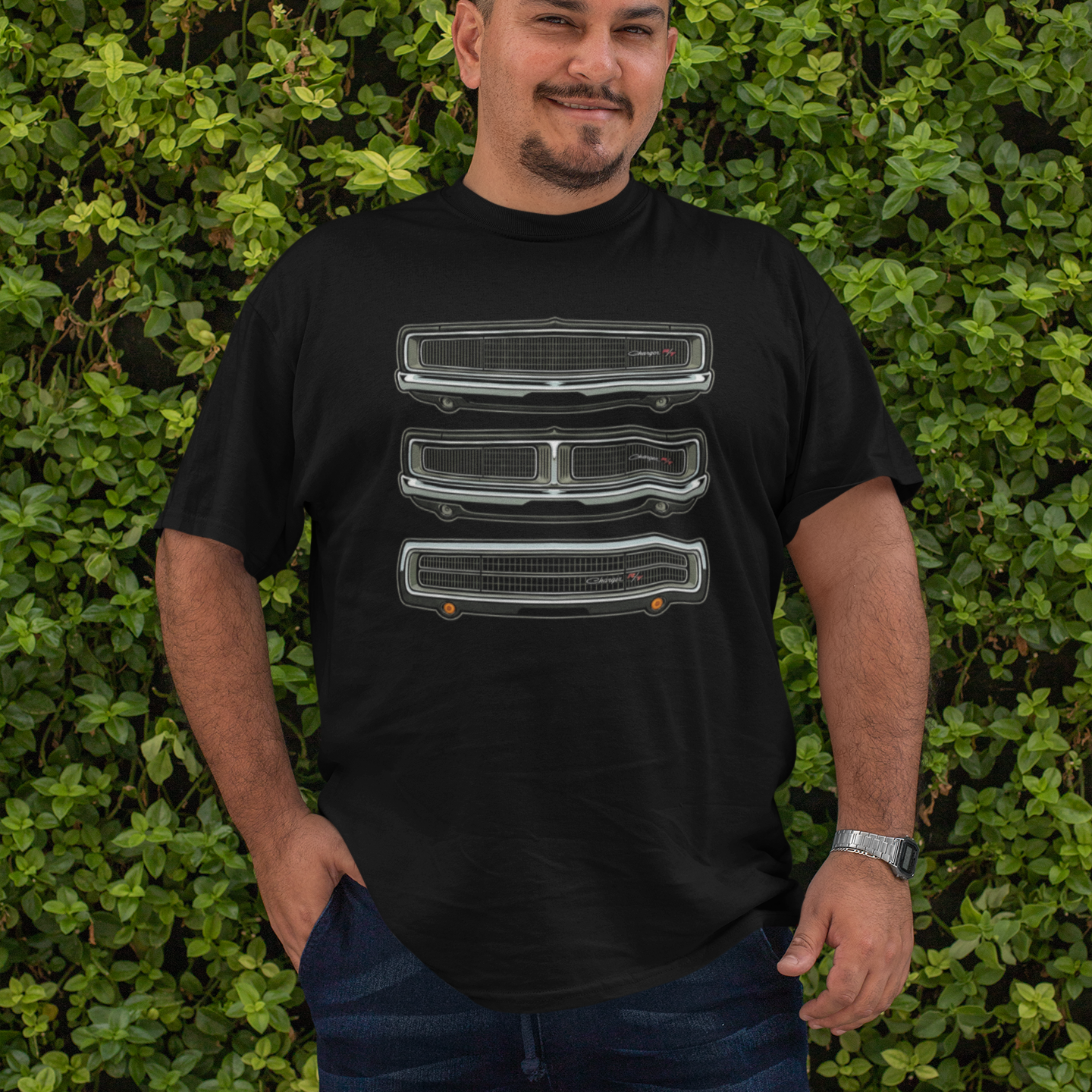 Man wearing a black t-shirt with graphic design in front of a green leafy background