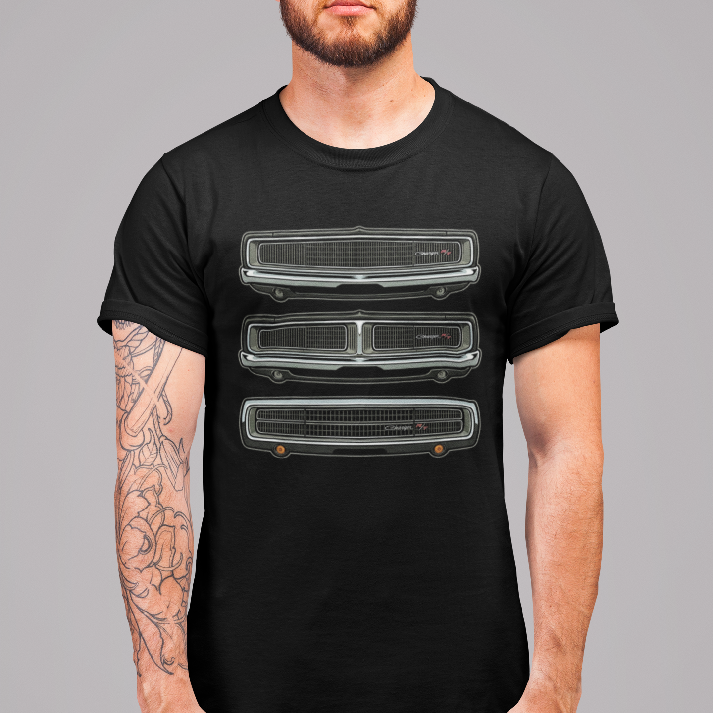 Man wearing a black t-shirt with a graphic design on a gray background